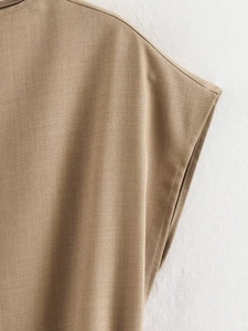 Detailed view of the tan twill fabric stitching and structural design on women's vest