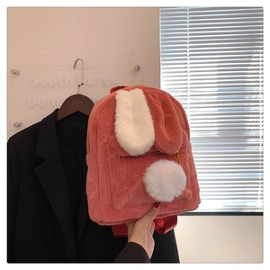 Detail of pink plush backpack with long white bunny ears and soft faux fur texture