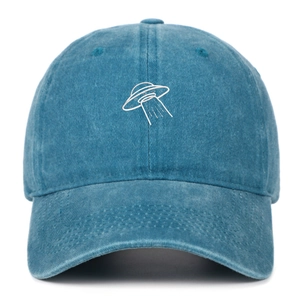 Macro detail of UFO embroidery on washed vintage cotton baseball cap with retro texture