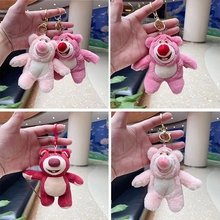 Detail of cute strawberry bear plush keychains in pink and red with metal hooks