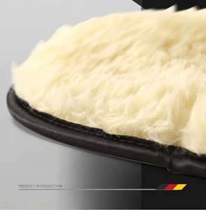 Macro detail of dense cream wool car wash mitt with premium black leather piping trim