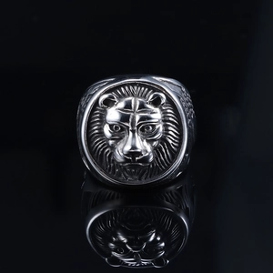 Detailed macro shot of vintage silver lion head embossed ring with metallic texture