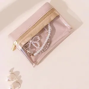 Pink velvet jewelry storage bag with clear window and gold zipper for necklaces