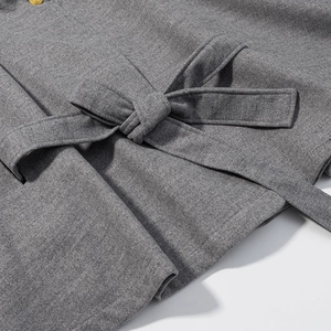 Detail view of the belted waist and textured grey wool fabric on the casual short coat