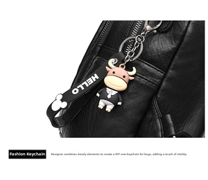 Detail of soft black lychee leather bag featuring a tuxedo calf charm and HELLO strap