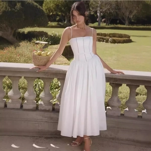 Elegant white camisole midi dress with lace stitching and A-line waist in a garden setting