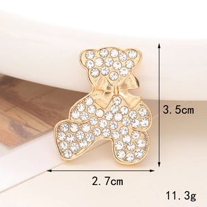 Detail view of a gold-plated rhinestone bear charm with dimensions 3.5cm by 2.7cm