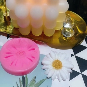 Detail of pink silicone mold with white daisy flower crafts for DIY resin projects