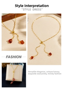Detail of adjustable gold Y-necklace with brown geometric resin charms and box display