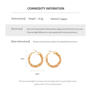 Macro detail of 3cm gold-plated textured hoop earrings made of heavy high-quality copper