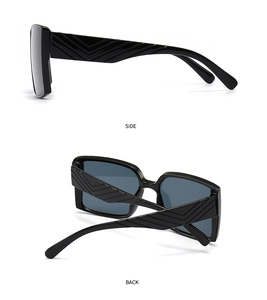 Detail view of black square sunglasses featuring 3D V-shaped geometric texture on side temples