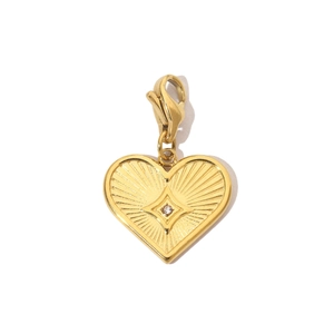 Detailed view of a golden heart pendant with a central diamond and spring clasp on white back