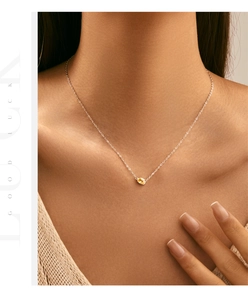 Detail of s925 silver necklace with yellow oval gemstone pendant worn on neck