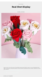 Detail of handcrafted crochet rose bouquet with colorful yarn flowers in a white ceramic vase