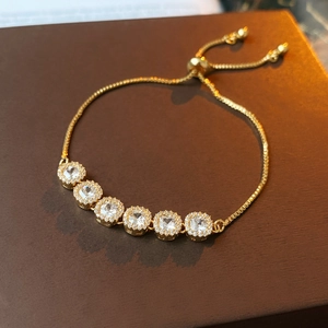 Close-up of gold-plated square zircon bracelet with halo setting and bolo clasp