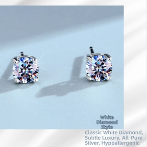Macro shot of silver stud earrings featuring classic round-cut diamonds in a six-prong setting