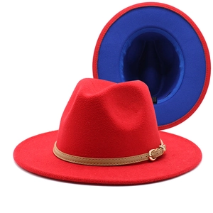 Detail of red wool fedora with blue interior, brown leather band and metal buckle