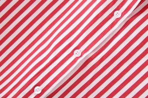 Close-up of red and white striped poplin shirt showing texture and white buttons