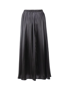 Detail of high waist elastic waistband with pleats on a black satin midi skirt