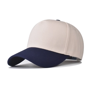 Detail view of cotton baseball cap with beige crown and navy blue brim contrast