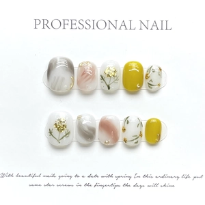 Macro view of short square press-on nails with marble texture and floral nail art