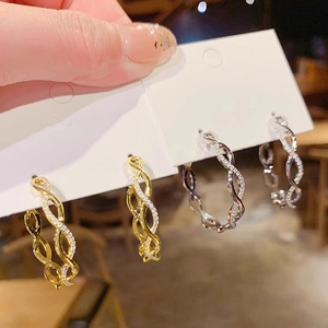 Twisted rope hoop earrings in gold and silver finish with sparkling pave zircons