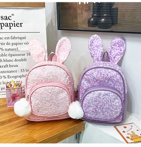 Pink and purple sequin backpacks with bunny ears and fuzzy pom pom charms for kids