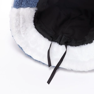 Winter plush bucket hat with blue fabric outer, warm white faux fur trim and black lining