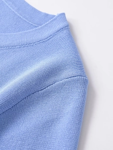 Close-up of soft light blue knit T-shirt showing ribbed neckline and fine stitching