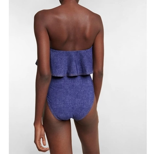Detailed back view of one-piece bandeau swimsuit with blue denim print and ruffle trim