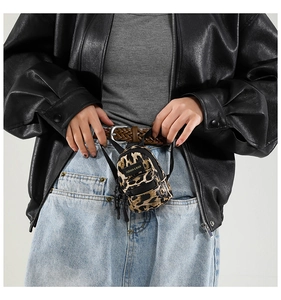 Mini leopard print crossbody bag worn on the waist for a stylish outdoor streetwear look