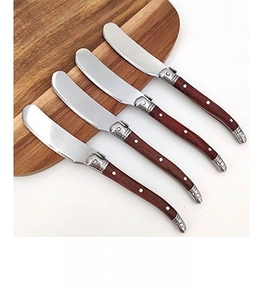 Set of four classic butter knives with wooden handles and polished metal blades