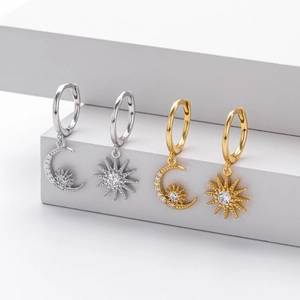 Detail view of S925 sterling silver sun and moon hoop earrings with pavé cubic zirconia
