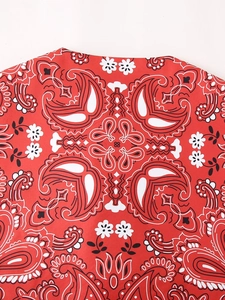 Close-up of red paisley print fabric texture and collar detail on women's cotton vest