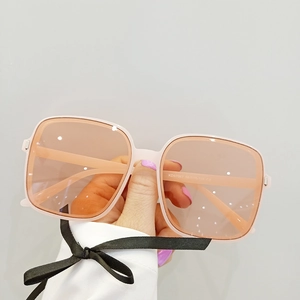 Close-up of pink oversized sunglasses with orange lenses and KD97067 temple details