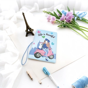 Detail of light blue cartoon passport holder with elastic band and girl on a scooter