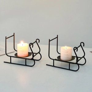 Set of two black metal sleigh candle holders in minimalist Nordic style for home decor