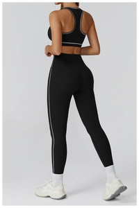 Detail view of black yoga set with white contrast piping and slimming back silhouette