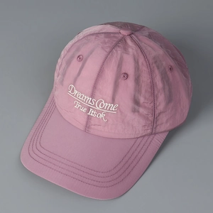 Close-up of white embroidered text on pink quick-dry fabric baseball cap detail
