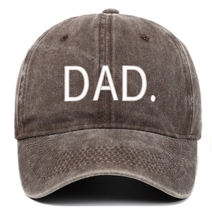 Close-up of vintage brown washed baseball cap featuring white embroidered DAD text on front