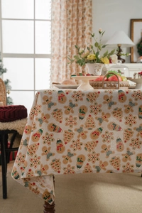 Linen blend tablecloth detail featuring gingerbread man and snowman Christmas patterns