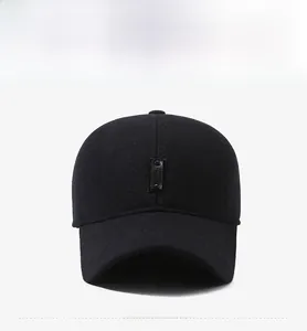 Front view of black wool baseball cap with rectangular patch and ear flaps for winter