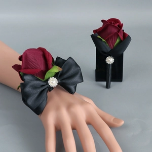 Burgundy rose wedding boutonniere and wrist corsage set with black satin bow and pearls