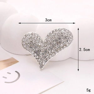 Makro-Detail von Herz-Strass-Schuhschmuck mit Größen- und Gewichtsangaben im Bild