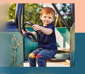 Detail of dinosaur patches on boys' navy cotton joggers with ribbed cuffs for active kids