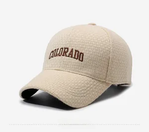 Close-up of beige waffle knit baseball cap with brown Colorado embroidery and black brim