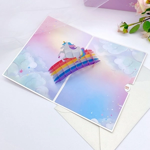 3D pop-up birthday card featuring a rainbow unicorn and dreamy cloud paper carvings