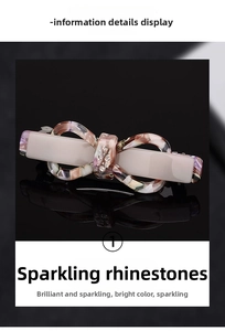 Detail view of acetic acid bow hair clip with marble pattern and sparkling rhinestones