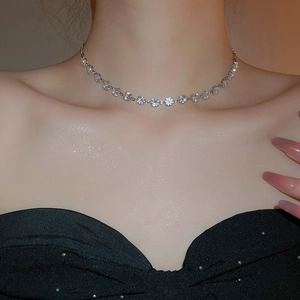 Close-up of sparkling zircon round pendant necklace on model's neck for elegant look