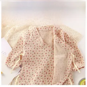 Detail of baby floral cotton gauze kimono top with delicate side-tie closure design